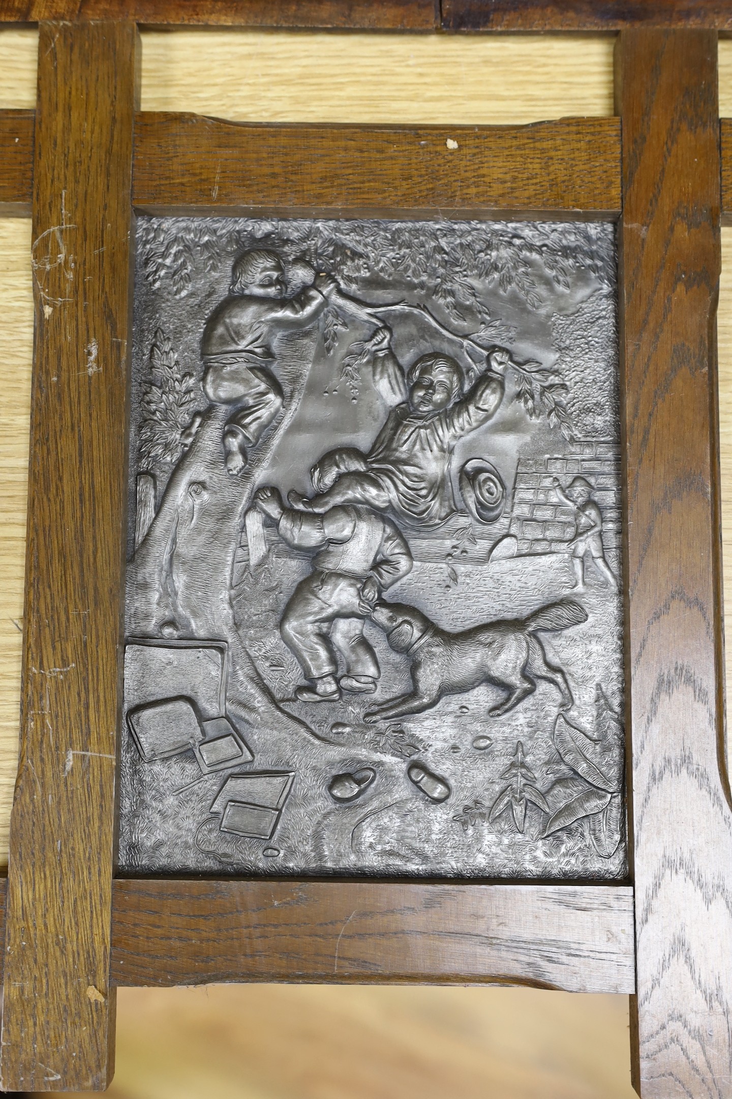 Three assorted cast metal panels together with a carved walnut panel, 39x40cm